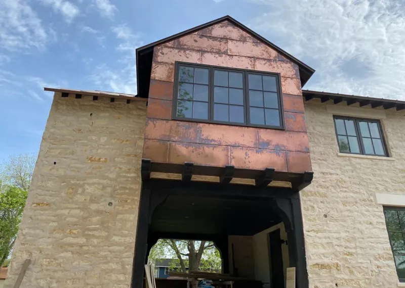 Copper metal panel facade on a stone building for Metal Roof Coating in Cincinnati