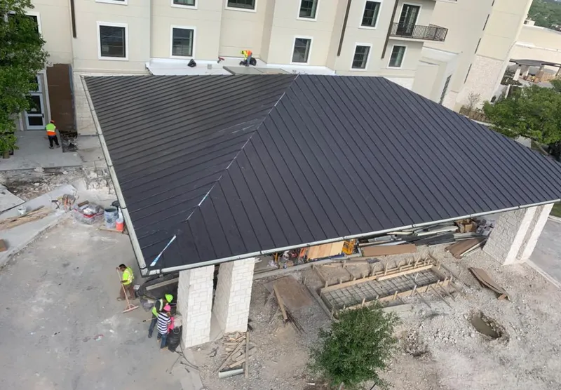 Metal roofing installation team working on a commercial building in Cincinnati