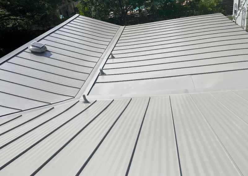 Solar attic fan installed on a metal roof for Roof Ventilation in Cincinnati